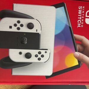 Nintendo Switch OLED with White Joy‑Con and Black Dock